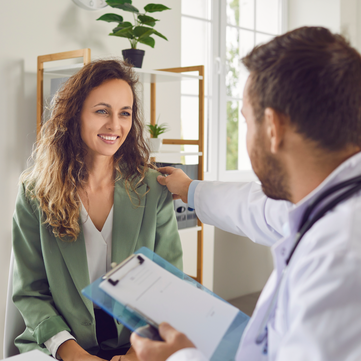Medical professional discussing care with a patient in a clinical setting, illustrating effective communication in eLearning for Healthcare.